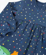 Frugi kids dress laid flat showing the repeating stars print and elasticated cuff detail on navy organic cotton fabric