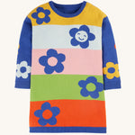 The colour-block and blue sleeve side of the Frugi Zola Reversible Knitted Dress - Blue Tang/Retro Floral. The colous on the body of the dress are yellow, light blue, light pink, light green and red. With navy blue, bold flower print. The arms of the dress are royal blue, with colourful flower prints
