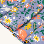 A closer view of the twirly skirt fabric on the Frugi Sofia Skater Dress - Rainforest Friends, which shows the animal and flower/leaf wildlife print