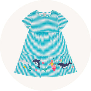Frugi Pixy Dress - Sea Moss Stripe / Sealife - GOTS organic cotton, short sleeved, twirly tiered dress with a gathered waist. Blue stripes with mermaid and sea creature appliques around the bottom tier. 