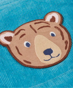 A close up of the Frugi durgan cord dungarees in boat blue showing the brown bear patch detail