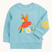 Frugi organic cotton jumper laid flat. In light blue with a red playful hummingbird design on the front and a yellow flower patch on the sleeve.