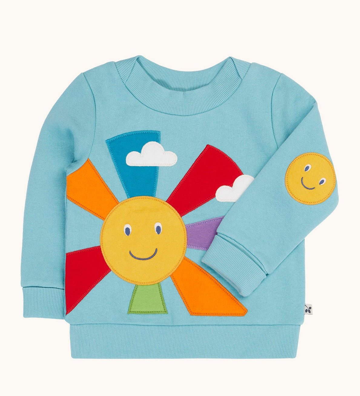 Frugi organic cotton jumper laid flat. In light blue with a smiling sun design on the front and a smiling face patch on the sleeve.