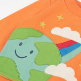 Frugi kids jumper laid flat showing a close up of the cute planet earth and star applique on the front on orange organic cotton fabric
