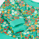 Frugi kids jumper laid flat showing close up of the repeating floral print and elasticated turn up cuffs on green organic cotton fabric