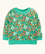 Frugi GOTS 100% organic cotton kids jumper in green with a repeating colourful floral design. Features elasticated cuffs, neck line and hem