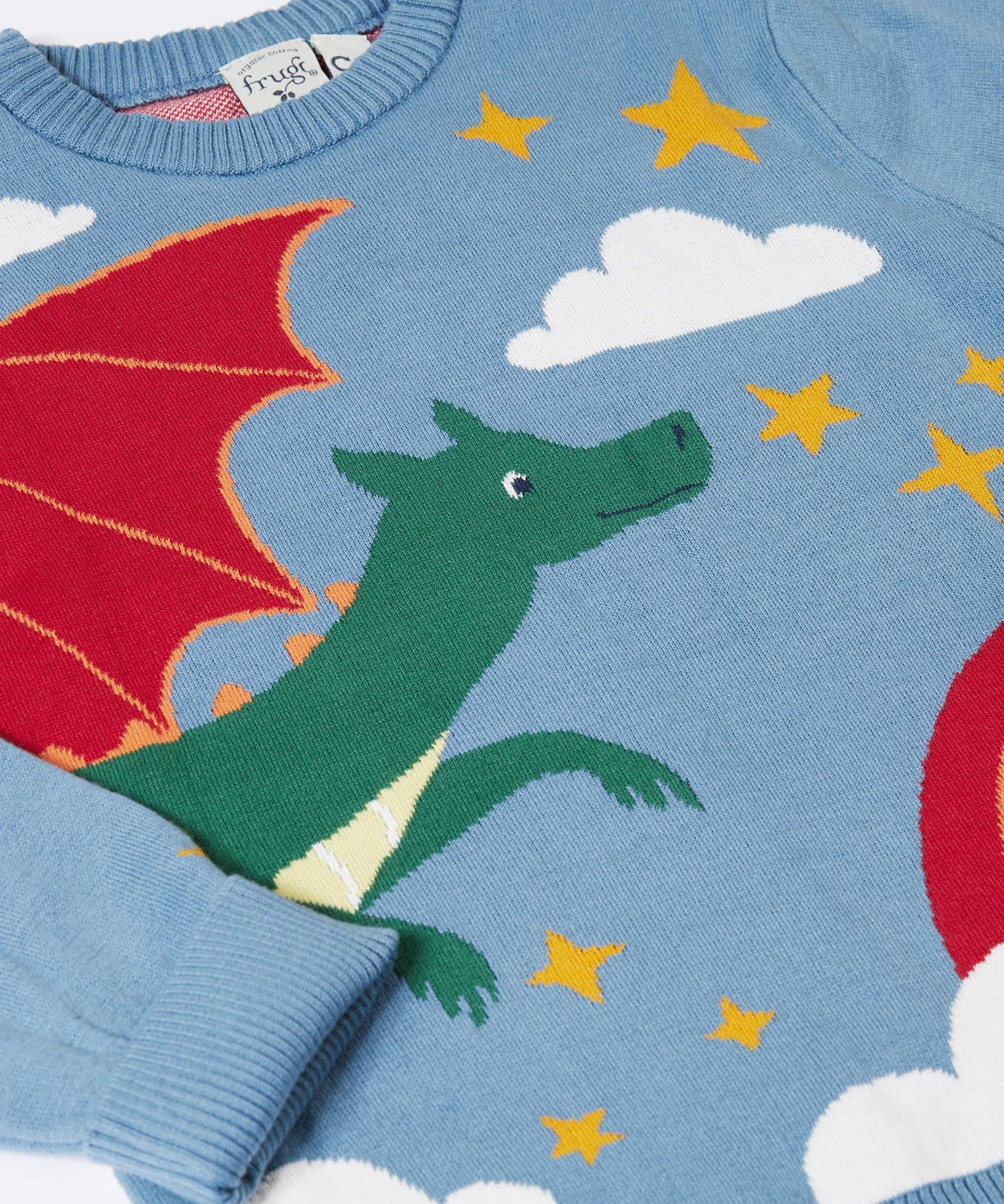 A close up of the flying green dragon design on the Frugi elwood knitted jumper in dragon skies available at Babipur. 