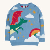 Frugi elwood knitted jumper in dragon skies available at Babipur. A GOTS organic cotton jumper in light blue with a playful flying dragon design wrapping around the jumper. Features button fasteners on the shoulder.