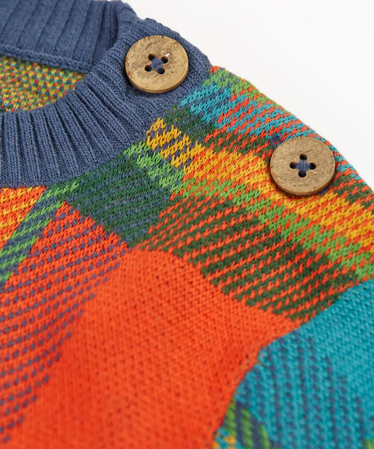 Frugi knitted kids jumper laid flat showing close up of the shoulder button detail for easy dressing