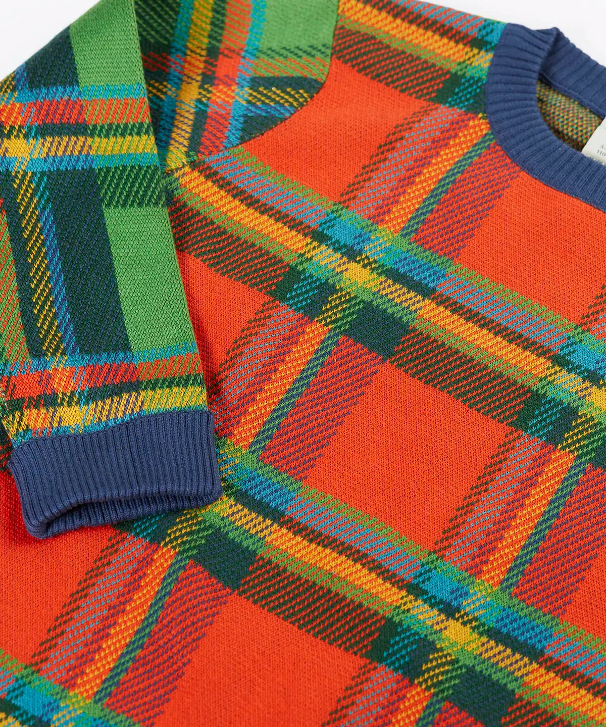Frugi knitted kids jumper laid flat showing close up of the tartan design on organic cotton fabric
