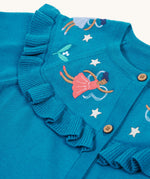 A closer look at the beautiful embroidered fairies on the Frugi Romi Ruffle Cardigan - Deep Water/Fairies. The image also shows the ruffled collar fabric, and stars surrounding the fairies.