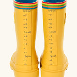 Back of the Frugi natural rubber, waterproof puddle buster wellingtons in yellow showing the rainbow strip on the top and a fun splash meter 