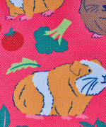 Frugi explorers backpack in guinea pig muddle showing repeating guinea pig and vegetables design on pink material