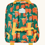 Back of Frugi explorers backpack in green with a repeating highland cow design. Features a name tag and buckle fastener on the straps