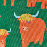Frugi explorers backpack in green with showing close up of the repeating highland cow design.
