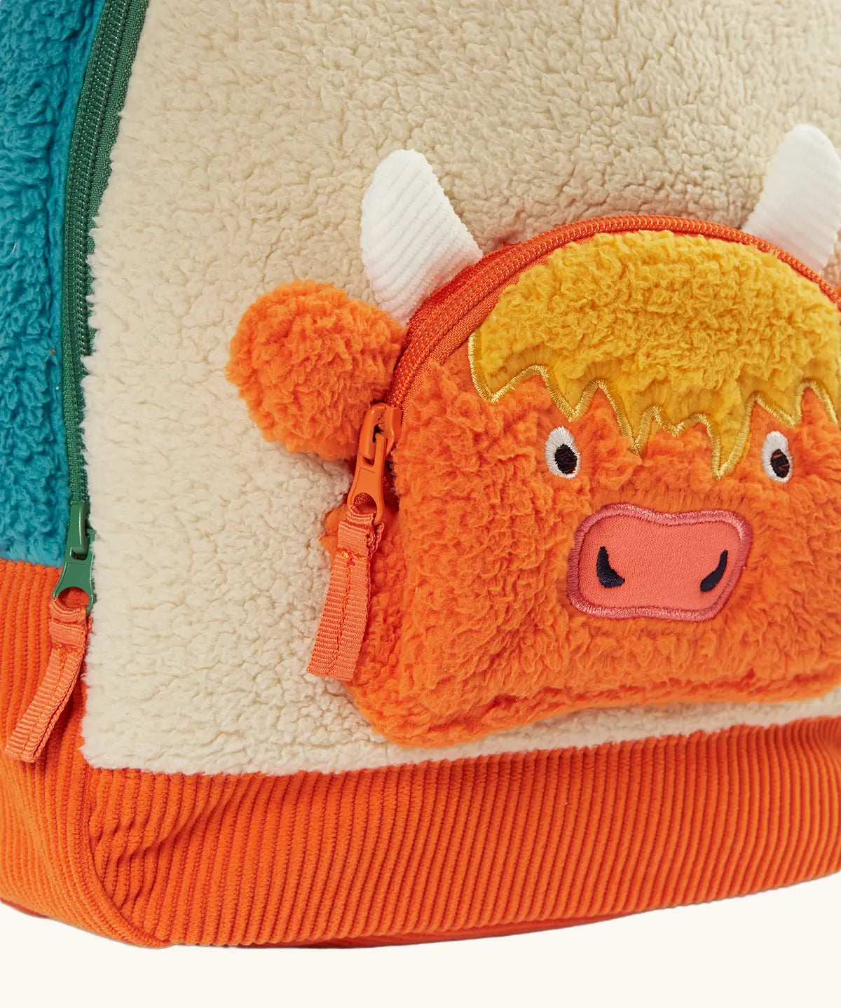 Frugi Highland cow fleece character backpack showing a close up of the Highland cow zipped front compartment