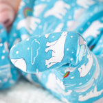 The foot of the Frugi Easy Dressing Babygrow - Winter Tails, fully covering the toes to keep them nice and warm. The polar bear print is also on the bottom of the feet