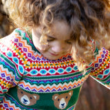 A close up of a child wearing the Frugi fowey fairisle bear knitted jumper showing the fairisle detail