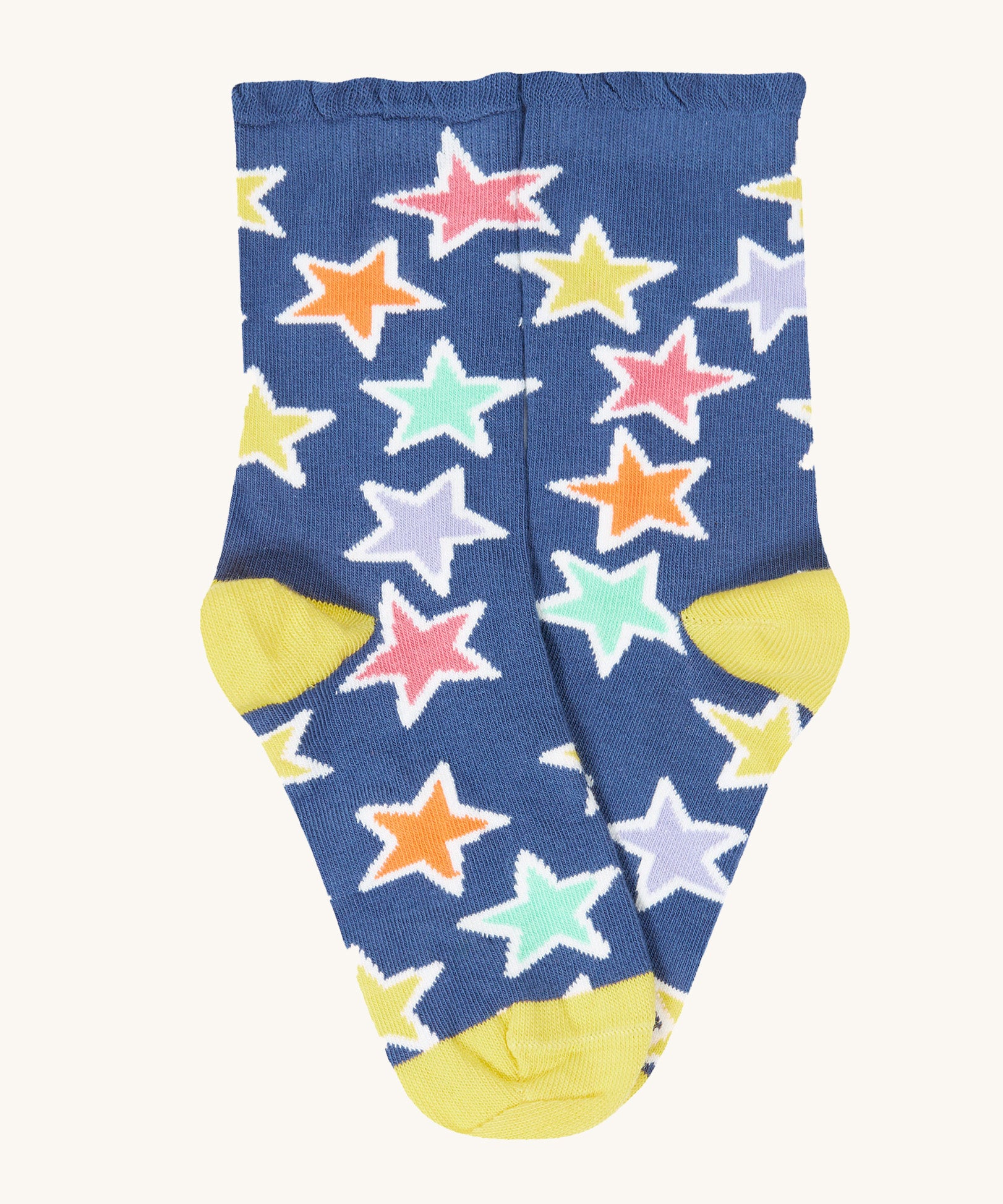 The blue with bold stars socks from the Frugi Frill Socks 2 Pack in stars available at Babipur. Sock features a gentle frill around the ankle and a yellow heel/toe panel
