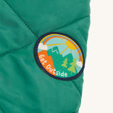 The Get Outside patch on sleeve of the Frugi Robin Reversible Quilted Jacket - Teal/Moon
