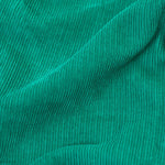 A closer look at the green cord of the Frugi Lacey Reversible Dungaree - Iguana/Autumn Friends