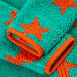 A closer look at the cuffs on the Frugi Zipped Ted Fleece Jacket - Bonfire Stars, showing the green fleece, orange stars and piping