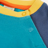 Frugi horizon raglan long sleeve organic cotton top laid flat showing close up of a popper fasteners on the shoulder for easy dressing