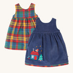 Frugi Inara Cord Reversible Dress - Navy Blue/Rainbow Check. A beautiful Navy Blue, corduroy dress with a festive house and robin applique detail on one side, and the other side is a rainbow check print