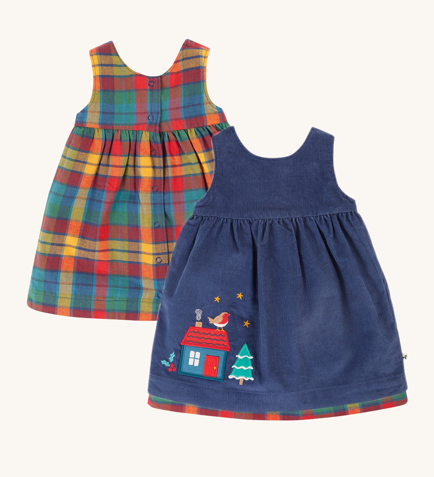 Frugi Inara Cord Reversible Dress - Navy Blue/Rainbow Check. A beautiful Navy Blue, corduroy dress with a festive house and robin applique detail on one side, and the other side is a rainbow check print