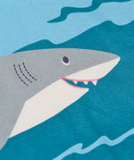 Frugi Iori hotchpotch t-shirt laid flat showing playful swimming shark design on GOTS organic cotton fabric