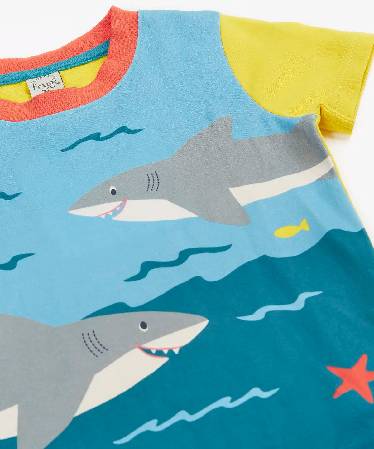 Frugi Iori hotchpotch t-shirt laid flat showing playful swimming sharks design and yellow short sleeves