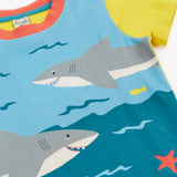 Frugi Iori hotchpotch t-shirt laid flat showing playful swimming sharks design and yellow short sleeves