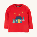 Frugi Ira Interactive Applique Top - True Red/Winter Cottage. A lovely, long sleeve, organic cotton, festive jumper in red. With a cosy home, gold star and snowy tree applique detail