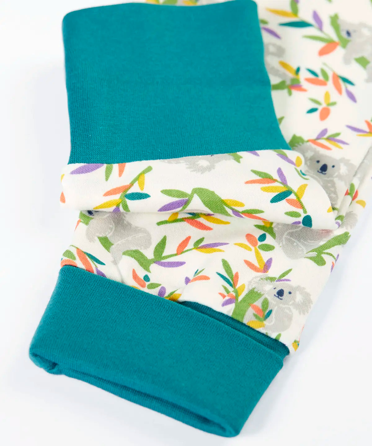 Frugi GOTS 100% organic cotton pyjama top in white with a a repeating koala print showing close up of the teal turn up cuffs