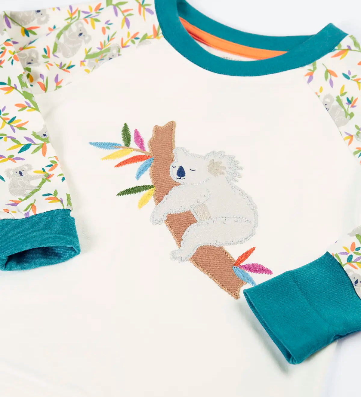 Frugi GOTS 100% organic cotton pyjama top in white with a sleeping koala applique on the front and teal turn up cuffs