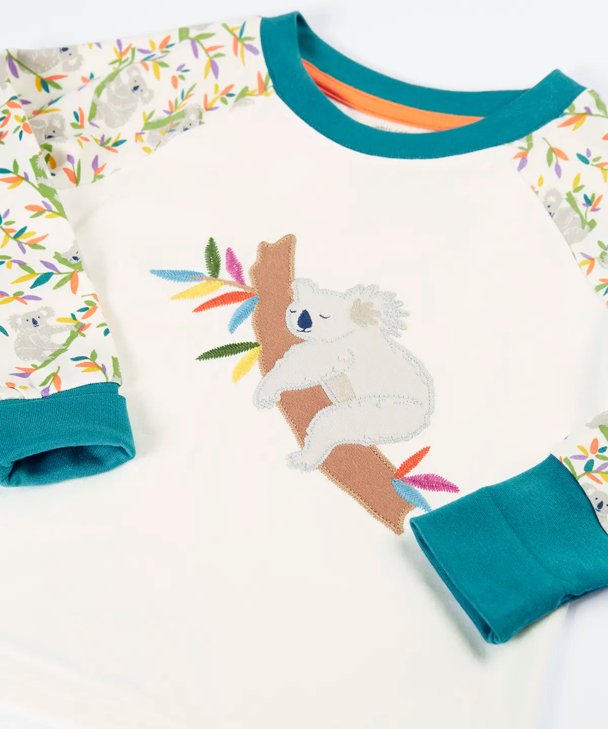 Frugi GOTS 100% organic cotton pyjama top in white with a sleeping koala applique on the front and teal turn up cuffs