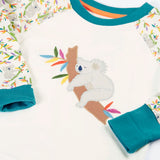 Frugi GOTS 100% organic cotton pyjama top in white with a sleeping koala applique on the front and teal turn up cuffs