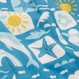 Frugi blue Kai shorts laid flat showing repeating beach inspired designs on GOTS organic cotton fabric