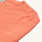 The popper fasteners on the shoulder of the Frugi Anna Applique Top - Cantaloupe/Fairy