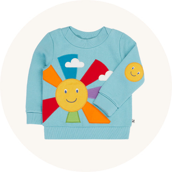 Frugi Easy On Jumper in light blue Lichen with large smiling Sun applique and rainbow rays, made from organic cotton, to represent Frugi jumpers and cardigans at Babipur.