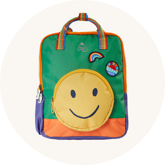 Frugi Ramble Rainbow A4 size Backpack in green with large smiley yellow face front pocket, orange base, rainbow carry strap, purple bottle pocket to represent Frugi bags at Babipur.