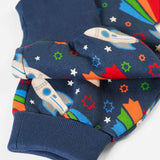 Frugi's GOTS organic cotton big hooded snuggle suit in navy with repeating flying rocket prints showing close up of the turned up leg cuffs
