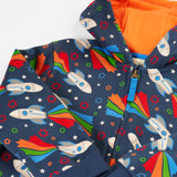Frugi's GOTS organic cotton big snuggle suit in navy with repeating flying rocket prints and a orange inner liner on the hood