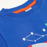 A closer look at the collar on the Frugi Little Creature Applique Top - Blue Tang/Rocket. Part of the space/rocket applique is showing at the bottom right of the image
