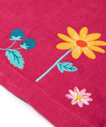A closer look at the embroidered flower detail on the Frugi Coco Cord Dress - Lingonberry/Squirrel