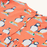 A closer look at the popper fasteners on the Frugi Dee Dress - Puffin Pals