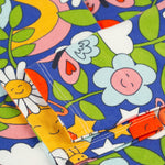 A closer look at the bottom of the sleeves in the Retro Happy print, folded across the Frugi Sofia Skater Dress - Retro Happy