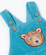 A close up of the Frugi durgan cord dungarees in boat blue showing the button fastener detail