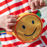 Child's hands opening the Frugi's kids happy hotchpotch bum bag