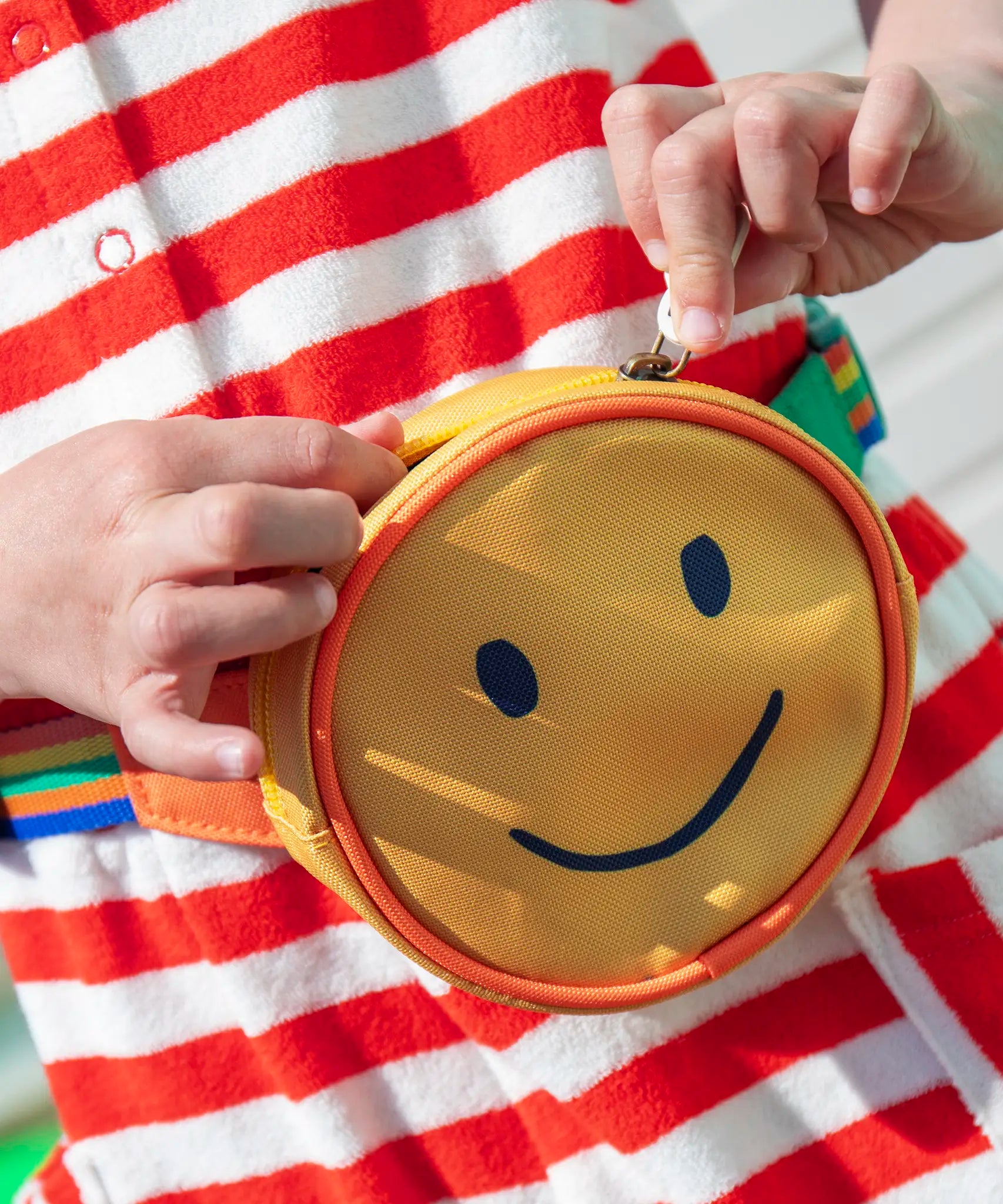 Child's hands opening the Frugi's kids happy hotchpotch bum bag
